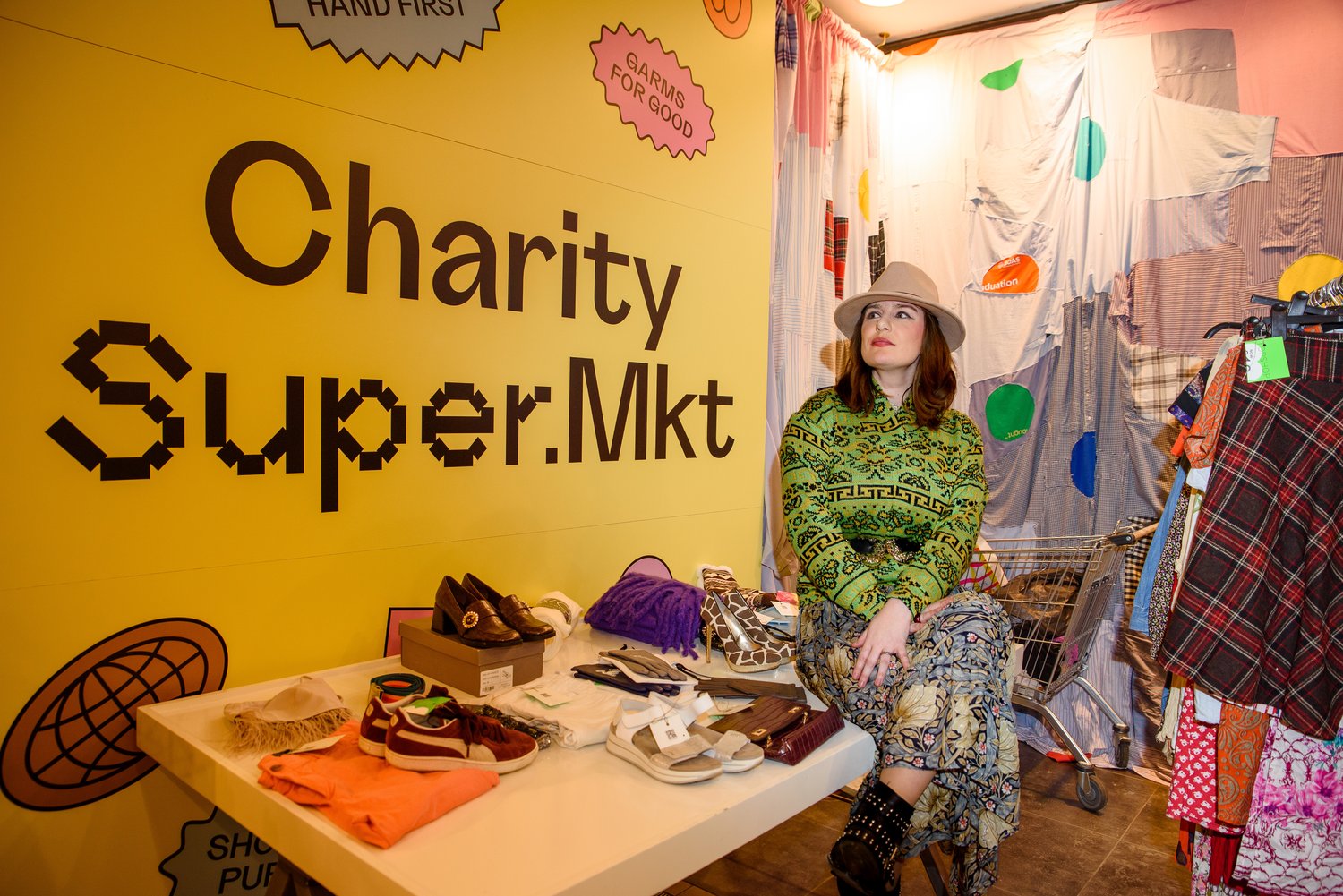 Lady sitting on a table displaying clothing