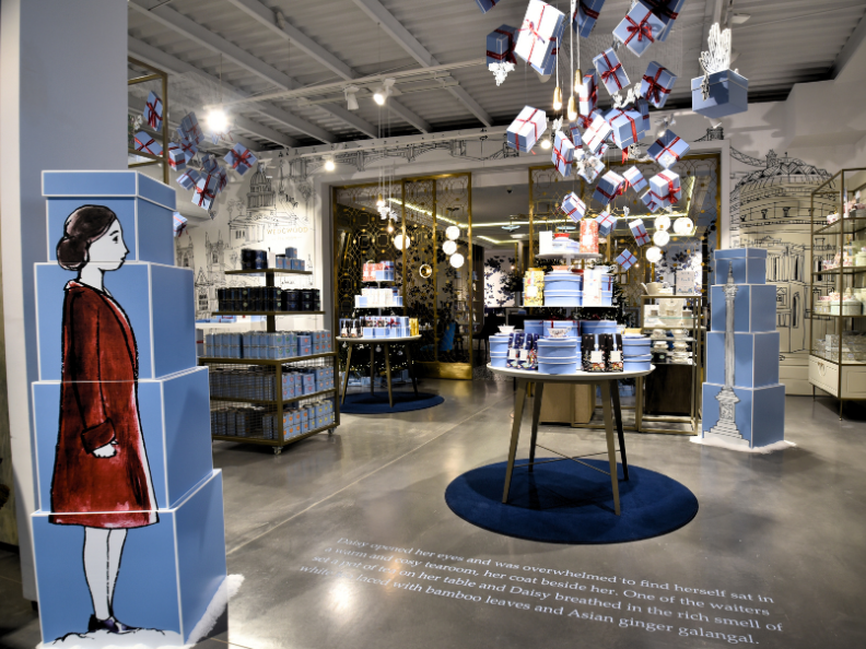 Cardboard retail display picturing a girl and christmas presents