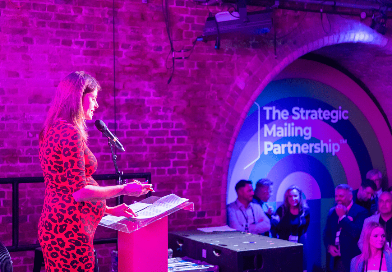 Lady at podium with wall graphics