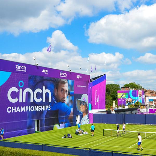 Large Cinch advertising graphics building wrap next to tennis court