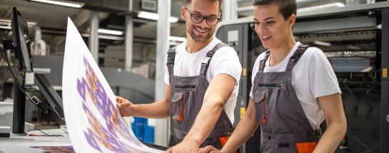 2 people looking at print