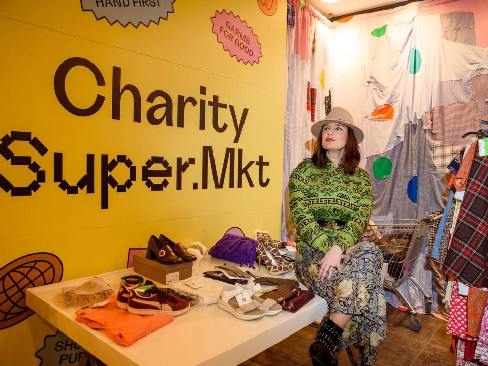 Lady sitting on a table displaying clothing